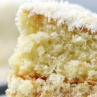 Coconut Cake · Vanilla cake with a condensed milk glaze, shredded coconut flakes, and Swiss meringue butter...