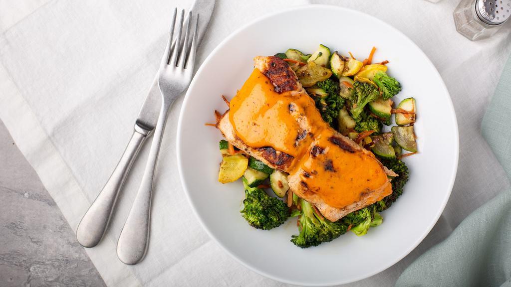 Salmon & Veg · Fresh cut salmon, grilled and served on a bed of green bell pepper, broccoli, yellow squash, shredded carrot, and zucchini. Topped with grilled onion and cajun sauce.