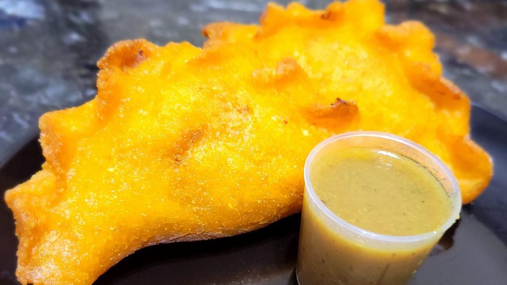 Curry Chicken Empanada (1) · A Caribbean twist on the traditional Colombian empanada. It's filled with Jamaican curry chicken and potatoes served with a side of spicy curry gravy.