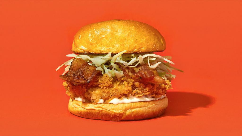 Bacon Ranch · Our signature fried chicken served on a toasted bun and topped with crispy bacon, shredded cabbage, and creamy ranch.
