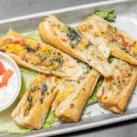 Southwest Eggrolls · Smoked chicken, black beans, corn, jack cheese, red peppers, and spinach wrapped in a crispy...