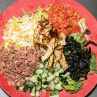 Classic Cobb Salad · Grilled chicken over mixed greens with diced tomatoes, cucumbers, bacon, avocado, black oliv...