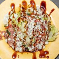Sinatra'S Wedge Salad · Iceberg wedge topped with fresh crumbled bleu cheese, diced tomatoes, cucumbers, crumbled ba...