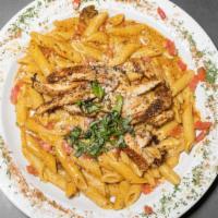Cajun Chicken Pasta · Blackened chicken, mushrooms, tomatoes, and scallions tossed with penne in a spicy alfredo s...