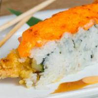 American Dream Roll · Inside out with shrimp tempura, eel, cream cheese and cucumber, then topped with baked salmo...