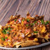 Ford'S Original Nachos · Your Choice of Pulled Pork or Grilled Chicken, Topped
with Bourbon BBQ Sauce, Ford's Beer Ch...
