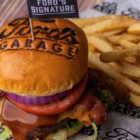 The Ford'S Signature Burger · Tillamook® Aged Sharp Cheddar Cheese, Applewood Smoked Bacon, Bourbon BBQ Sauce, Chopped Rom...