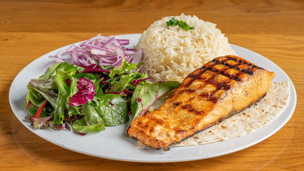 Salmon · Grilled marinated salmons. Served with rice and salad.