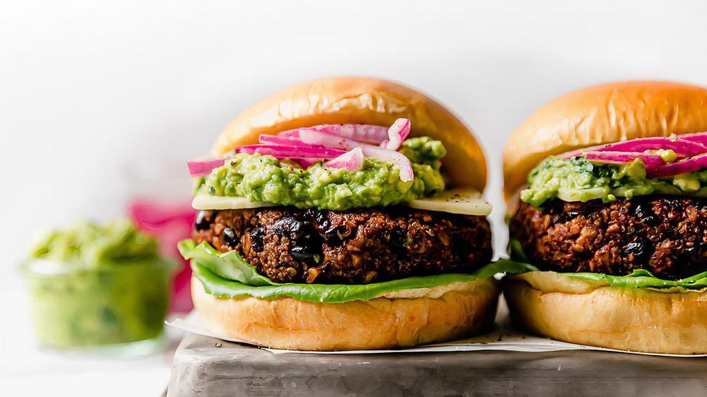 The Ultimate Black Bean Burger · This is a succulent plant based burger made with a  black bean patty then topped with lettuce, avocado, tomato, onions, pickles and served in a wheat bun
