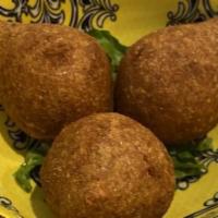 Fried Kibbeh · Meat and crushed wheat shell, stuffed with pine nuts, onions and minced meat.