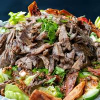 Shawarma Salad · Fresh salad topped with your choice of shawarma meat or chicken served with two styles greek...