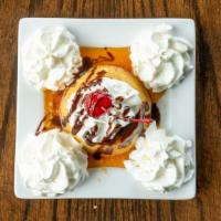 Flan · Mexican custard with caramel topping and chocolate drizzle topped with whipped cream.