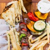 Churrasco Skewer Platter · Served w/ Pita, Greek Fries, Grilled Veggies & Tzatziki Sauce