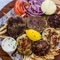Bifteki Family Platter · Beef, Chicken & Lamb Patties, served with Sliced Tomatoes & Onions, Greek Fries, Pita Bread,...