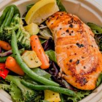 Salmon  · Grilled organic Scottish Salmon with peppers, tomatoes and onions.  Garnished with lemon and...