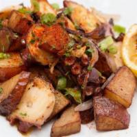 Pulpo Salteado · Sautéed Octopus with Potatoes, Red  Onion, Chili Cascabel, paprika and Grilled Lemon