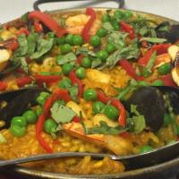 Paella Del Día · Traditional Spanish paella, with peas, shrimp, squid, mussels, chicken and chorizo with saff...