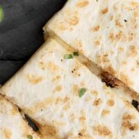 Quesadilla · Grilled flour or whole wheat tortilla filled with your choice of meat, cheddar, and Jack che...