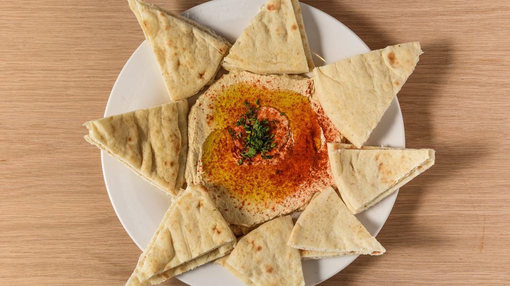 Hummus App · Our famous dip that will rock your world! Chick peas thickly puréed with garlic, tahini, & lemon juice. Topped with E.V.O.O. & paprika.