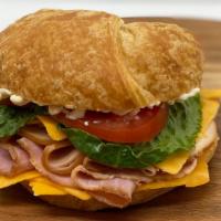 Club Croissant · Honey ham, Turkey, Cheddar Cheese, Lettuce, Tomato and Mayonnaise