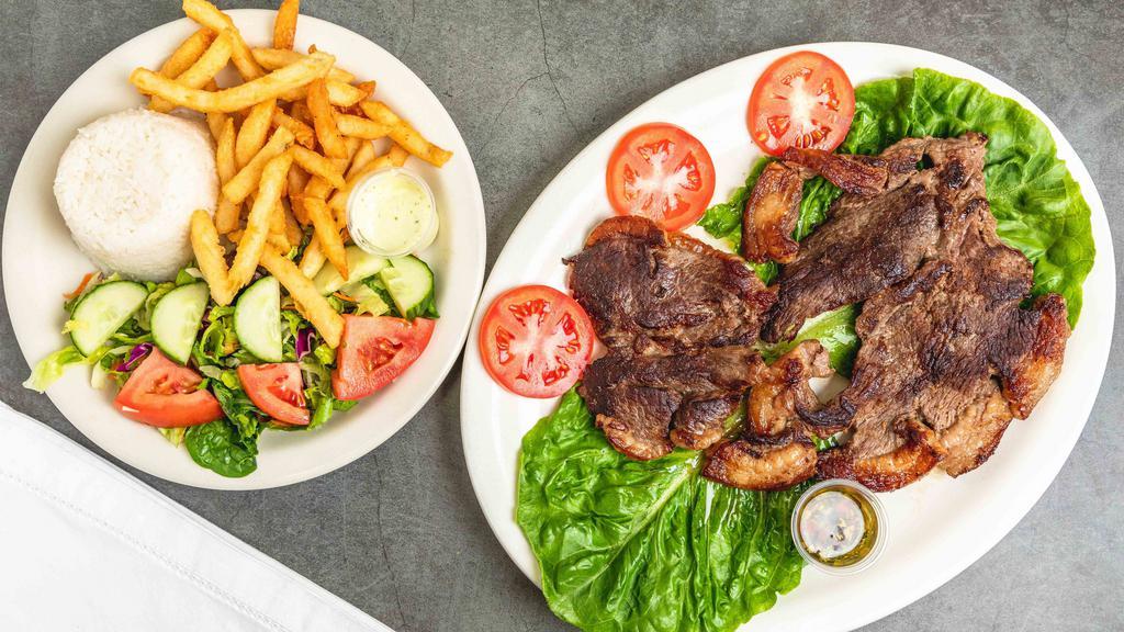 Punta De Anca (Picanha) · Grilled steak picanha (12 oz). Served with white rice, salad, and French fries or sweet plantains.
