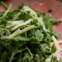 Beef Carpaccio · Thinly-sliced raw beef topped with arugula salad, parmesan shaves, Italian dressing