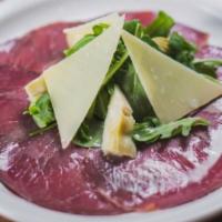 Bresaola · Thinly-sliced dry beef topped with arugula, artichokes, parmesan shaves Italian dressing