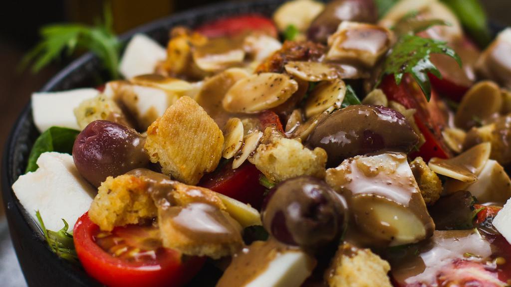 Cherry Tomato Salad · mixed greens, cherry tomatoes, fresh mozzarella, almonds, homemade croutons, black olives, Italian dressing