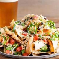 Beer Cheese Nachos · Corn tortilla chips smothered in our Amber Ale beer cheese, black beans, tomatoes, green oni...