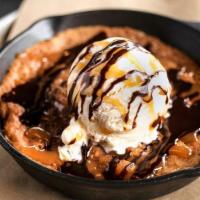 Salted Caramel Cookie Skillet · Fresh out of the oven salted caramel almond cookie, topped with vanilla bean ice cream and d...