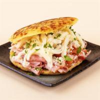 Ham And Cheese Arepa · Ham, shredded cheese, cilantro, and crumbled cotija cheese between two warm, fresh arepas.