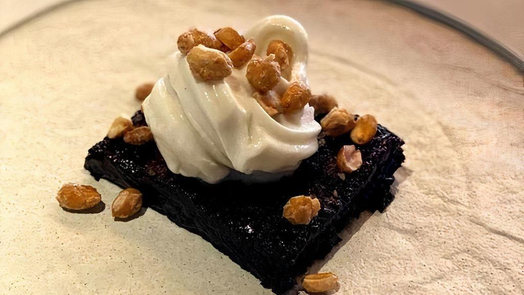 Chocolate Brownie* · Dark chocolate brownie with hot fudge, vanilla soft serve and candied peanuts (Contains Gluten and Nuts)