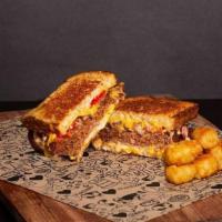 Vegan Melt Grilled Cheese · Wheat Bread, Beyond Burger® Patty, Vegan Cheese, Onions, Tomatoes and Vegan Cheese Sauce.