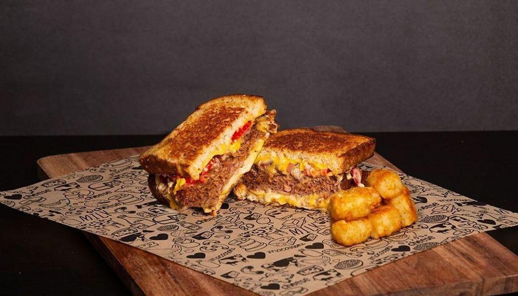 Vegan Melt Grilled Cheese · Wheat Bread, Beyond Burger® Patty, Vegan Cheese, Onions, Tomatoes and Vegan Cheese Sauce.