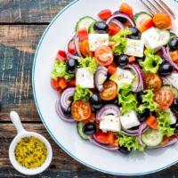 Greek Salad · House-famous medditerranean style salad made with lettuce, tomatoes, cucumbers, olives, pepp...