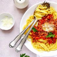 Spaghetti With Bolognese Sauce · Our number one seller, bolognese sauce mixed with house-made spaghetti. Served with two fres...