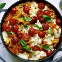 Baked Fettuccine · Oven baked roman style fettuccine pasta mixed in your choice of sauce. Served with two garli...