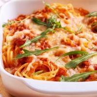 Baked Spaghetti · Baked spaghetti mixed with a choice of sauce. Served with two garlic rolls.