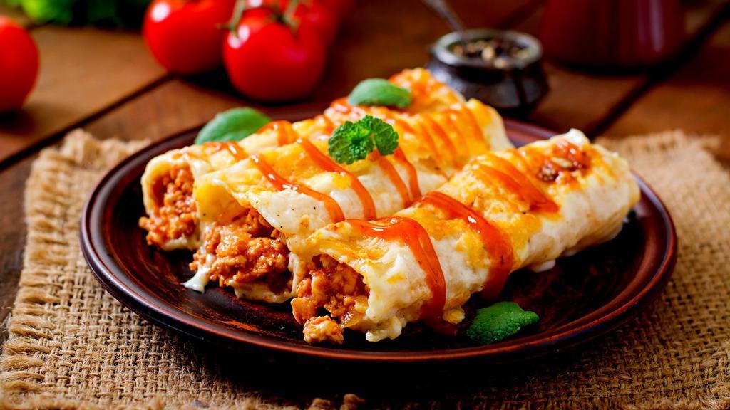 Baked Cannelloni · Fresh baked cannelloni mixed with choice of either cheese, meat, or spinach. Served with two garlic rolls.