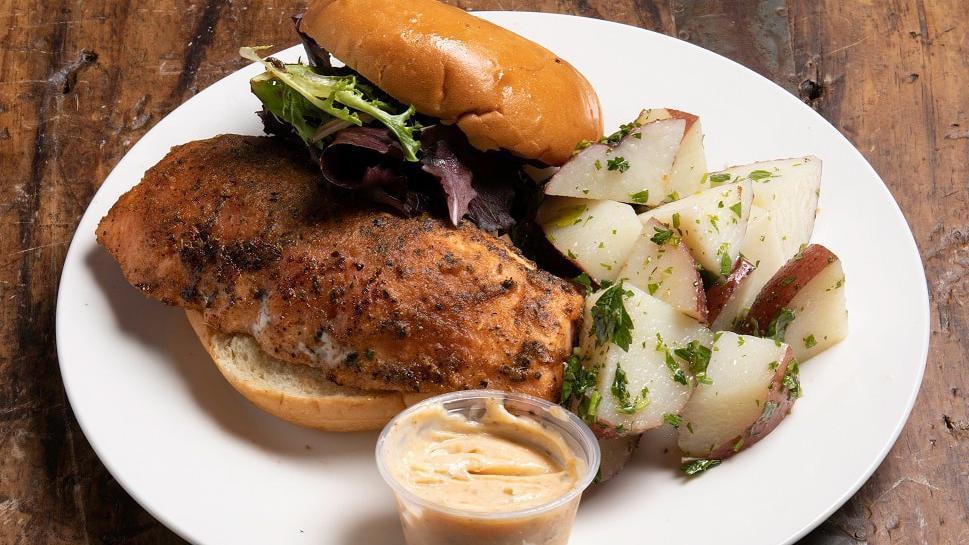 Sandwich - Salmon Filet Sandwich · Fresh salmon filet rolled in savory herbs & special blend spices on a Brioche Bun w/Lettuce.  Choose 1 of our delicious side items to complete your meal.
