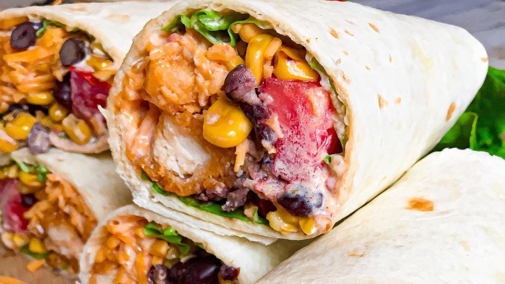 Southwest Chicken Wrap · Crispy or grilled chicken, lettuce, tomato, corn, black beans, shredded cheddar cheeses and a southwest dressing.