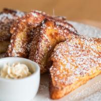 French Toast · Two thick slices of challah bread dipped in egg batter and griddled to a golden brown.