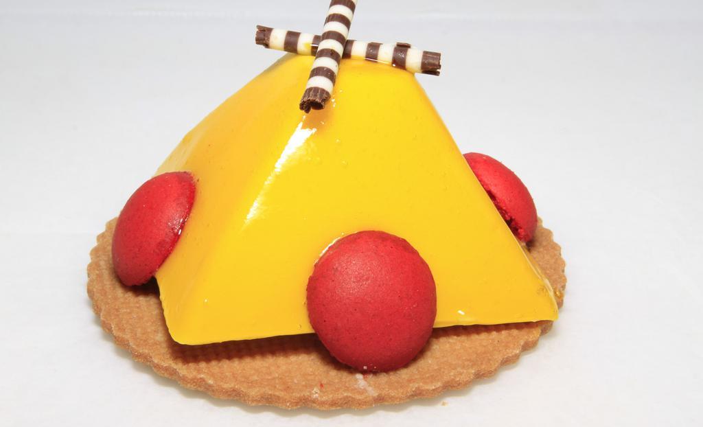 Passion Mousse · Passion mousse made with real passion fruit juice on an almond cookie.