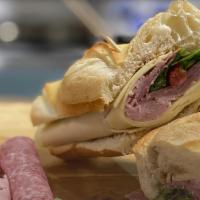 Prosciutto Sandwich · Prosciutto, confit tomatoes, greens pesto, provolone cheese, olive oil, balsamic vinegar.