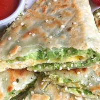 Breakfast Quesadilla · Scrambled eggs, bell peppers and cheese. Served with breakfast potatoes and refried beans/Hu...