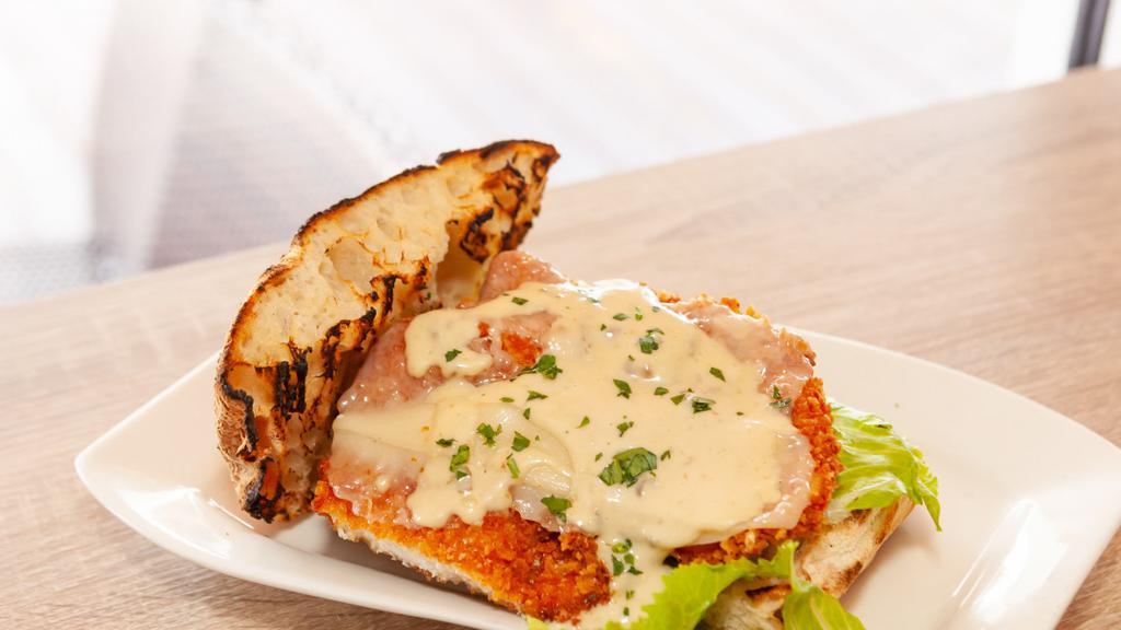 Chicken Milanese · Organic breaded chicken cutlet topped with Baby Arugula Salad, extra virgin olive oil finished with Parmigiano Reggiano