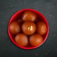 Gulab Jamun · Delicate dumplings made with condensed milk and soaked in a rose-flavored syrup.