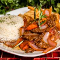 Lomo Saltado / Strips Of Sirloin · Marinated strips of sirloin (or other beef steak) with onions, tomatoes, french fries, and o...