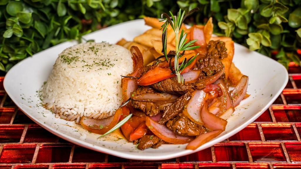 Lomo Saltado / Strips Of Sirloin · Marinated strips of sirloin (or other beef steak) with onions, tomatoes, french fries, and other ingredients; and is typically served with white rice and frensh fries.