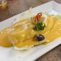 Papa A La Huancaina · Boiled potatoes topped with creamy yellow chile sauce.